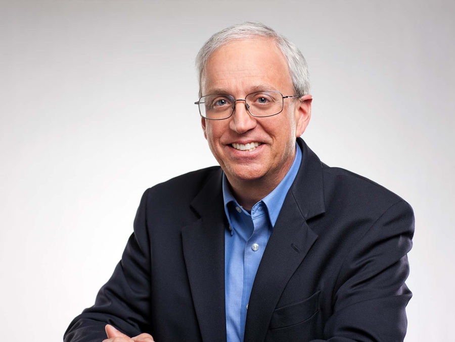 Portrait of man wearing a blue shirt and sports coat.