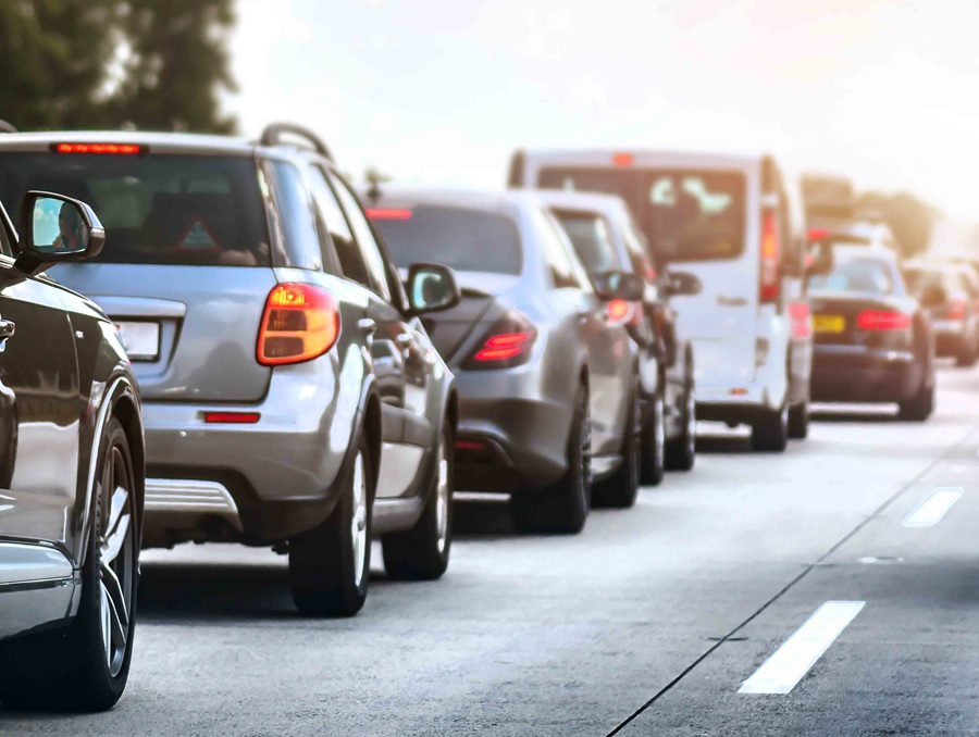 Six vehicles on a road driving away from the camera.