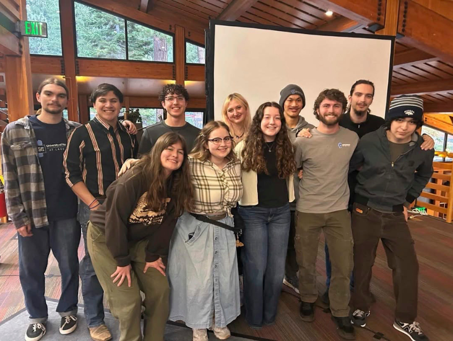 A group of University of Nevada, Reno at Lake Tahoe students pose together inside Prim Library on the Lake Tahoe campus.