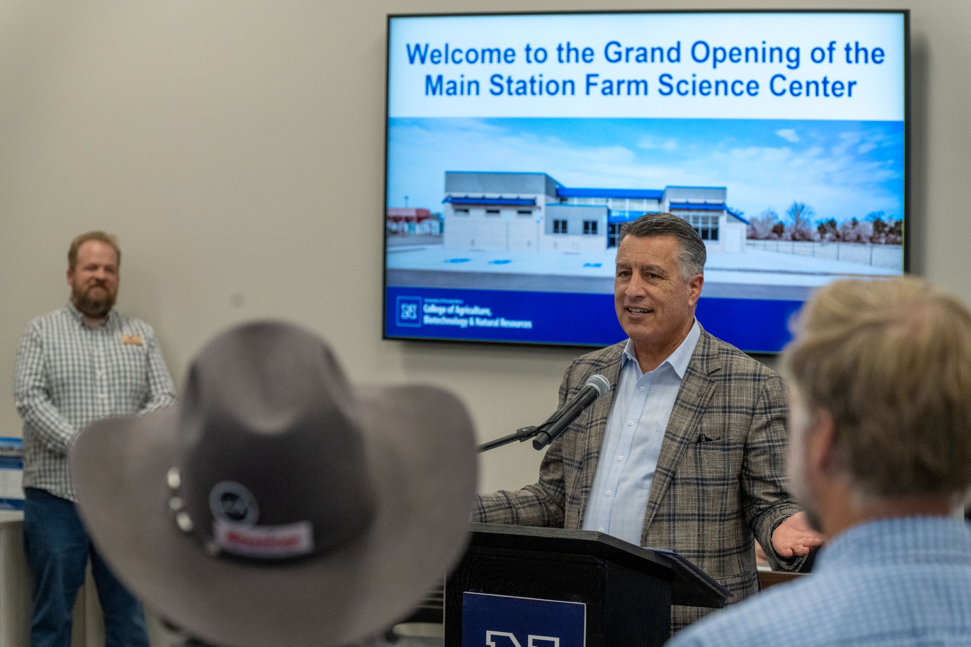 President Brian Sandoval addressing a group of people in a room. 