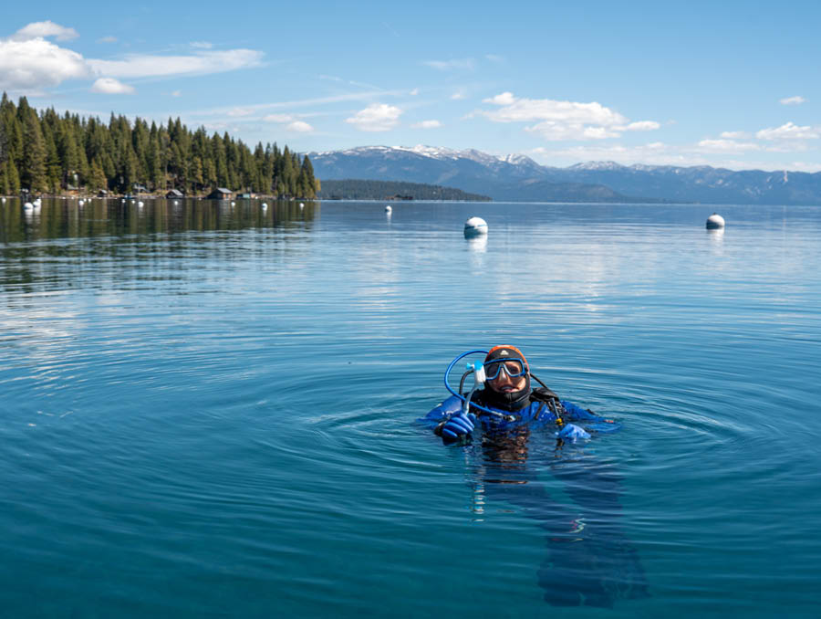 Emily Carlson swims to the surface of Lake Tahoe in her scuba gear.