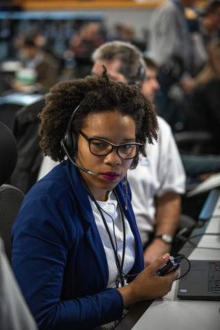 Photo of Ales-cia Winsley working with a headset on.
