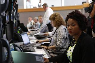 Two women monitor operations from their consoles at NASA.