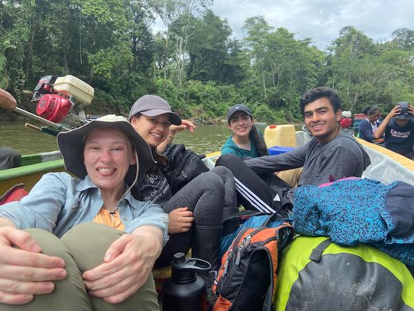 A smiling group of people crammed into a small boat, looking very happy.