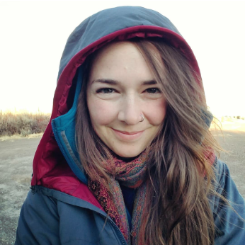 Jackie Dougherty in a winter jacket and scarf smiling.