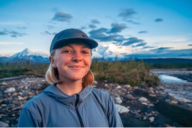 Johanne Albrigtsen smiling while standing near a riverbank.