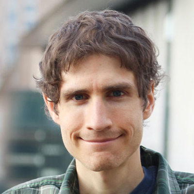 Daniel smiles at the camera in his headshot.