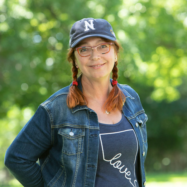 Headshot of Elena Pravosudova outdoors in a Nevada hat and Nevada Love t-shirt