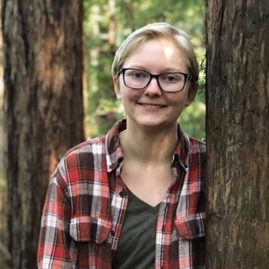 Kate Kerr standing by a tree