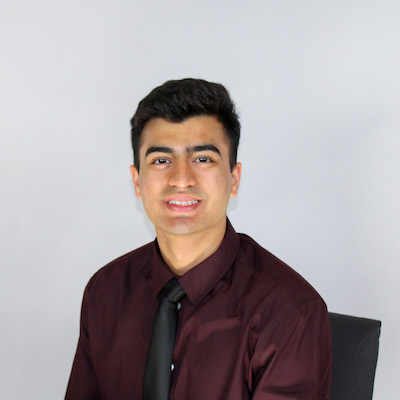 Rayan Laique headshot in a button up collard shirt with a tie.