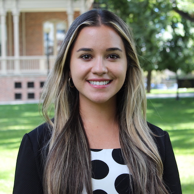 Headshot of Regina Flores on campus in front of Morrill Hall