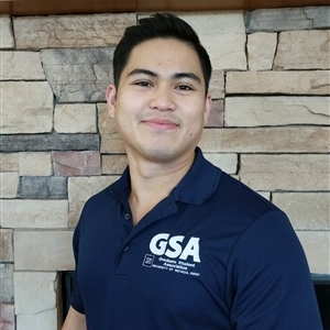 Robert Yturralde in front of the fire place in the student union