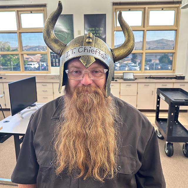 Frankie Clark wearing a horned helmet that says "I.T. Chieftan."