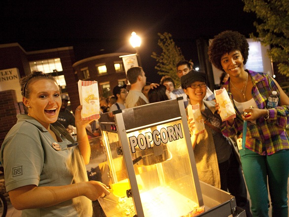 Students get popcorn at a club fair outside the JCSU