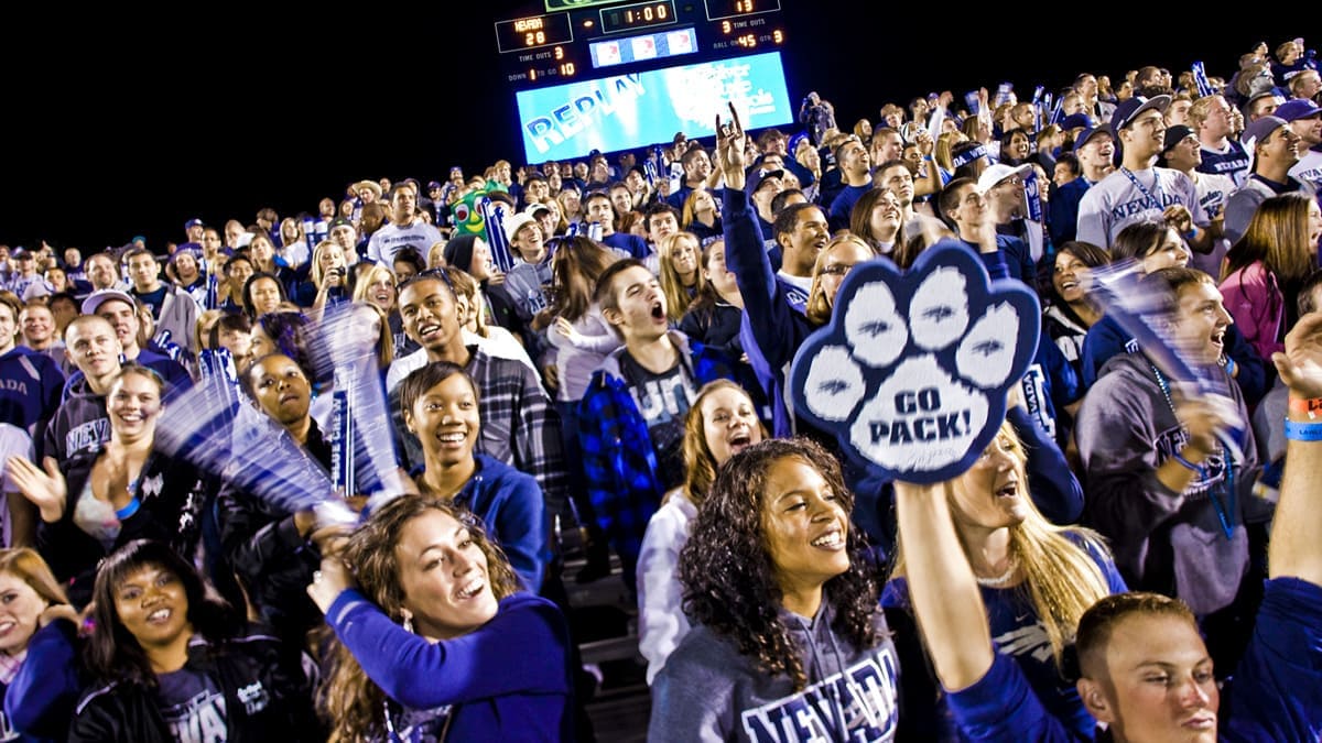 Students fill the stands at a Wolf Pack football game