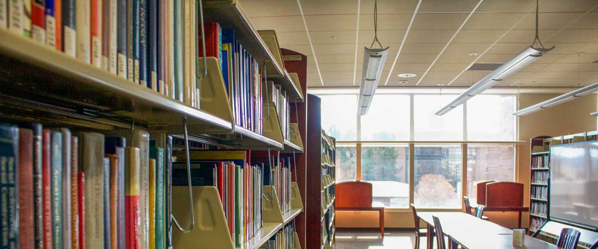 Rows of books in the Knowledge Center in the library stacks