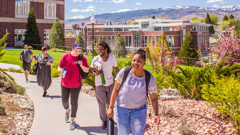 Students walk outside the Lombardi Recreation Center with the E. L. Wiegand Fitness Center visible in the background.