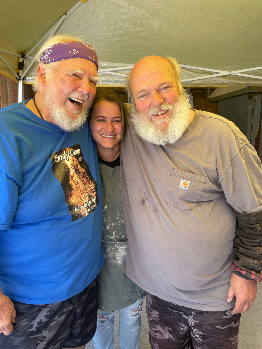 Three people pose for a photo