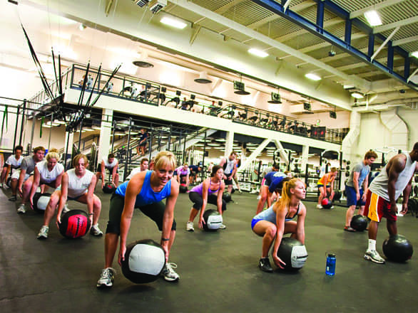 Individuals working at the E. L. Wiegand Fitness Center