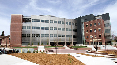 Exterior of the Davidson Math and Science Center, a modern facility with brick and steel siding, multiple stories and numerous windows, walkways and grass landscaping.