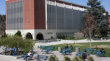 Hilliard Plaza, on the campus of University of Nevada, Reno, a large tree-lined quad area with Mack Social Science building behind the plaza.