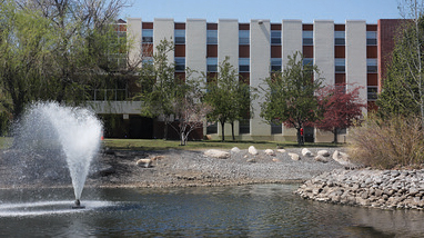 Exterior of Juniper Hall, a residence hall at the University of Nevada, Reno, a large, multi-story building that sits next to Manzanita Lake.