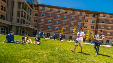 Exterior of Peavine Hall, a modern brick building on the campus of the University of Nevada, Reno, with large 